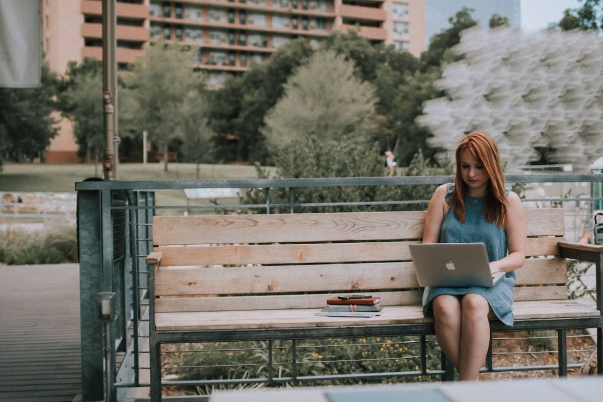 Woman working on a park bench