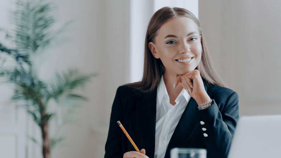 Woman smiling and writing